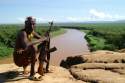 Old Karo warrior controlling the Omo river and Blumi tribe a